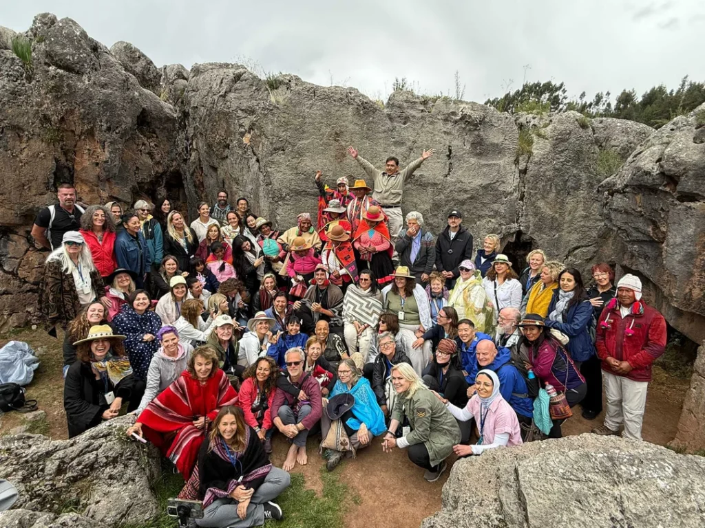 Group of travelers posing among stone ruins.
