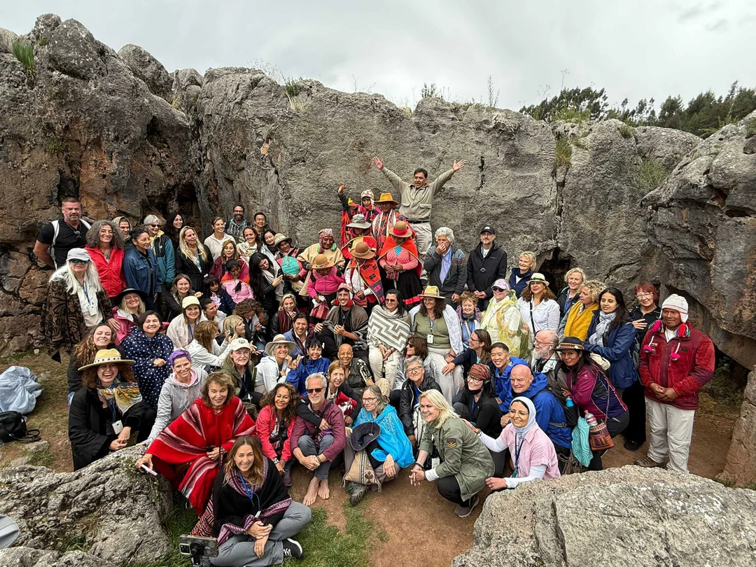 Group of travelers posing among stone ruins.